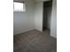 Bedroom features neutral walls and carpet, with sliding door closet at 5640 E 67Th Pl, Commerce City, CO 80022