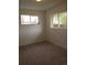 Bright bedroom with windows, carpet, and neutral paint at 5640 E 67Th Pl, Commerce City, CO 80022