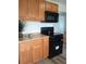 Well-equipped kitchen with wood cabinets and black appliances at 5640 E 67Th Pl, Commerce City, CO 80022