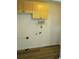 Laundry area with upper cabinets and wooden floors at 5640 E 67Th Pl, Commerce City, CO 80022
