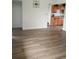 Bright room with wood floors and a view into the kitchen at 5640 E 67Th Pl, Commerce City, CO 80022