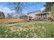 Spacious backyard with a trampoline, wooden fence, covered patio, and mature trees at 8975 S Coyote St, Highlands Ranch, CO 80126