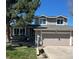 Charming two-story home featuring a well-manicured lawn and a two-car garage at 8975 S Coyote St, Highlands Ranch, CO 80126