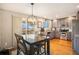 Spacious eat-in kitchen with stainless appliances and a dining area with backyard views at 8975 S Coyote St, Highlands Ranch, CO 80126