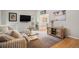 Cozy living room featuring a plush sofa, rustic wood accents, and neutral décor at 8975 S Coyote St, Highlands Ranch, CO 80126