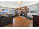Inviting living room featuring a cozy fireplace, built-in shelving, and hardwood floors at 8975 S Coyote St, Highlands Ranch, CO 80126