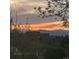 Stunning sunset view with vibrant colors over the community and distant mountains at 8975 S Coyote St, Highlands Ranch, CO 80126