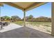 Large backyard with green grass, wood fence, and an outdoor patio area perfect for entertaining guests at 785 Iris St, Brighton, CO 80601