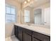 Bright vanity area with large mirror and a bright window at 785 Iris St, Brighton, CO 80601