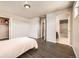 Comfortable bedroom features wood floors and access to an adjacent bathroom and walk-in closet at 785 Iris St, Brighton, CO 80601