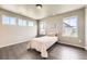 Cozy bedroom features wood floors, bright windows, and a comfortable space at 785 Iris St, Brighton, CO 80601