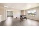 Bright bonus room with hardwood floors and game table in an open and airy living space at 785 Iris St, Brighton, CO 80601
