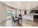Bright kitchen and dining area with granite counters, stainless appliances, and access to the backyard at 785 Iris St, Brighton, CO 80601