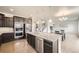 Open concept kitchen with stainless steel appliances, large island, and view to living area at 785 Iris St, Brighton, CO 80601