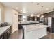 Modern kitchen with dark cabinets, stainless steel appliances, granite counters and a large island at 785 Iris St, Brighton, CO 80601