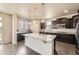 Modern kitchen with a large center island, pendant lighting, and stainless steel appliances at 785 Iris St, Brighton, CO 80601
