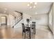 Open living room with dining table, hardwood floors and staircase at 785 Iris St, Brighton, CO 80601