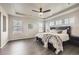 Spacious main bedroom with tray ceiling, wood floors, and large windows at 785 Iris St, Brighton, CO 80601