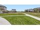 Picturesque neighborhood with green spaces, sidewalks, and attractive residential architecture at 785 Iris St, Brighton, CO 80601