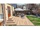 Backyard featuring a new deck and patio space, surrounded by mature landscaping and a privacy fence at 1582 Fairfax St, Denver, CO 80220