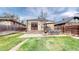 Backyard featuring a deck with an outdoor seating area and lush green grass at 1582 Fairfax St, Denver, CO 80220