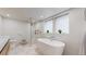 Modern bathroom featuring a soaking tub, frameless shower, and contemporary fixtures at 1582 Fairfax St, Denver, CO 80220