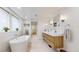 Contemporary bathroom featuring a soaking tub, wood vanity, and glass shower at 1582 Fairfax St, Denver, CO 80220