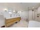 Well-lit bathroom with a double vanity, glass shower, and modern fixtures at 1582 Fairfax St, Denver, CO 80220