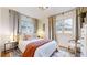Bright bedroom featuring a comfortable bed, large windows and a seating area at 1582 Fairfax St, Denver, CO 80220