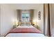 Inviting bedroom featuring a comfortable bed, large windows and bedside tables at 1582 Fairfax St, Denver, CO 80220