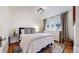 Charming bedroom featuring a comfortable bed, large window and a stylish dresser at 1582 Fairfax St, Denver, CO 80220