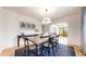 Elegant dining room featuring a large wooden table, stylish chairs, and modern light fixture at 1582 Fairfax St, Denver, CO 80220