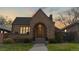 Charming brick home with arched entry, manicured lawn, and professional landscaping at 1582 Fairfax St, Denver, CO 80220