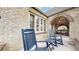 Inviting front porch with comfortable seating and arched brick entryway at 1582 Fairfax St, Denver, CO 80220