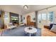 Bright living room with fireplace, modern furniture, and arched doorway to other rooms at 1582 Fairfax St, Denver, CO 80220