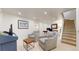 Relaxing living area featuring comfortable chairs, soft lighting, and a nearby staircase at 1582 Fairfax St, Denver, CO 80220