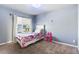 Bright bedroom featuring a single bed, window, and pink vanity at 4528 Andes St, Denver, CO 80249
