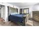 Bedroom with rustic wood furniture, carpet, and a large window with sunlight streaming in at 4528 Andes St, Denver, CO 80249