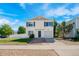 Well-maintained home featuring a tidy front yard, attached garage, and inviting entrance, showcasing a blend of comfort and curb appeal at 4528 Andes St, Denver, CO 80249