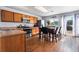 Functional kitchen featuring wood cabinets, stainless steel appliances, and an adjacent dining area with backyard access at 4528 Andes St, Denver, CO 80249