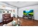 Relaxing living area featuring hardwood floors, comfortable seating, and a modern entertainment center, perfect for Gathering time at 4528 Andes St, Denver, CO 80249