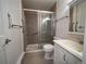 Bathroom with walk-in shower and safety bars, vanity, and toilet at 17973 E Iowa Dr, Aurora, CO 80017