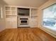 Living room features a fireplace with built-in shelving and bright windows at 17973 E Iowa Dr, Aurora, CO 80017
