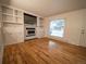 Bright living room boasts a fireplace with built-in shelves and gleaming hardwood floors at 17973 E Iowa Dr, Aurora, CO 80017
