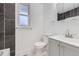 Well-lit bathroom featuring modern vanity and black tile accent wall at 621 Campo St, Denver, CO 80221