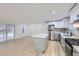 Bright kitchen with stainless steel appliances, large island, and neutral tones at 621 Campo St, Denver, CO 80221