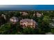 Wide aerial view showcasing a home nestled within a lush, green neighborhood at dusk at 96 Falcon Hills Dr, Highlands Ranch, CO 80126