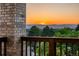 Serene balcony view of mountains and trees, framed by brick and wooden railing at 96 Falcon Hills Dr, Highlands Ranch, CO 80126
