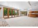 Large finished basement with a bar area and glass doors to the yard at 96 Falcon Hills Dr, Highlands Ranch, CO 80126