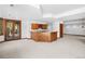 Finished basement with a wood bar area and back door access at 96 Falcon Hills Dr, Highlands Ranch, CO 80126